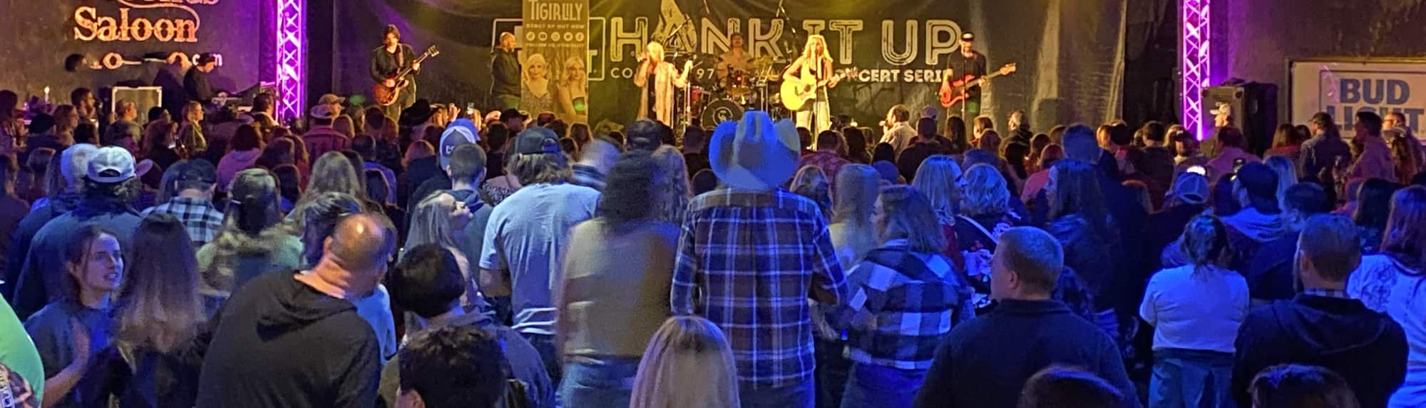 country concert with fans wearing cowboy hats Bloomington